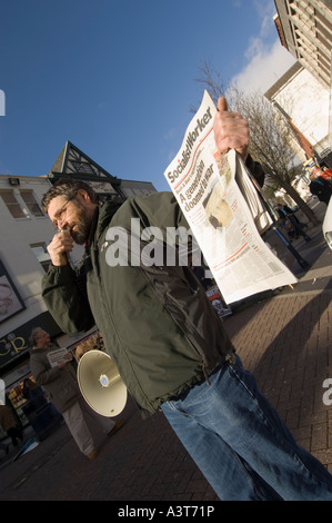 Socialist worker seller using megaphone to attract buyers of the newspaper Swansea Abertawe West Glamorgan Wales Stock Photo
