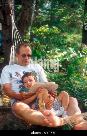 John West reads to his son Joey 4 during a camping trip in Algonquin Provincial Park Ontario Stock Photo