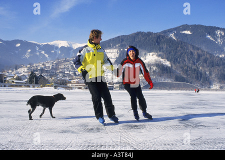 ice scating couple with dog, Austria, Alps Stock Photo