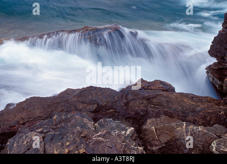 Lake Superior waves crash on the rugged shoreline of Presque Isle Park in Marquette Mich Stock Photo