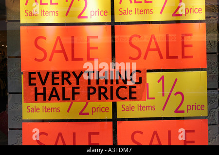 Shop windows with posters advertising half price sale Stock Photo