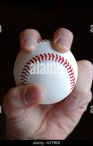 Hand holding baseball Stock Photo