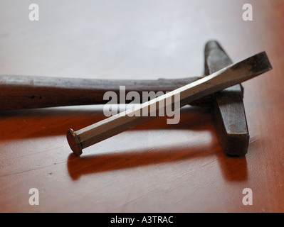 Antique Hammer and Chisel on wooden bench Stock Photo