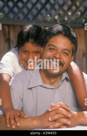 11 year old Mexican American girl hugging father Stock Photo