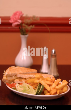 A PLATE OF CHEESE TOASTED SANDWICHES AND FRIES IN A CAFE UK Stock Photo