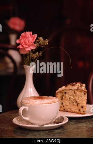 A CAPPUCINO COFFEE AND CAKE IN A CAFE UK Stock Photo