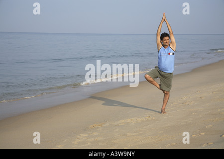 Indian man exercising on the beach - MR#703D Stock Photo