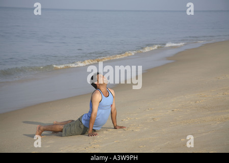 Indian man exercising on the beach - MR#703D Stock Photo