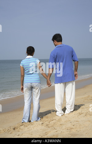 Couple standing together lovingly on the beach Stock Photo