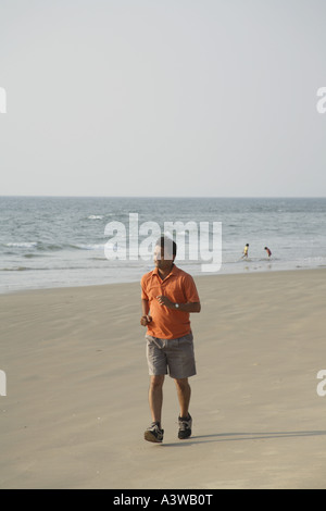 ANG 201698 South Asian Indian young man doing morning activity running on seashore MR 703D Stock Photo