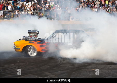 Australian burnout legend, Gary Myers, performing a massive burnout in his supercharged Ford Mustang muscle car Stock Photo