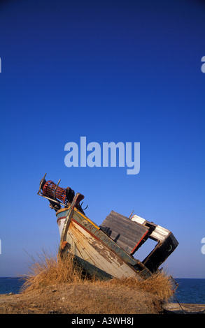 Abandoned fishing boat on the beach at Poros on the Greek Island of Kefallonia Greece Stock Photo