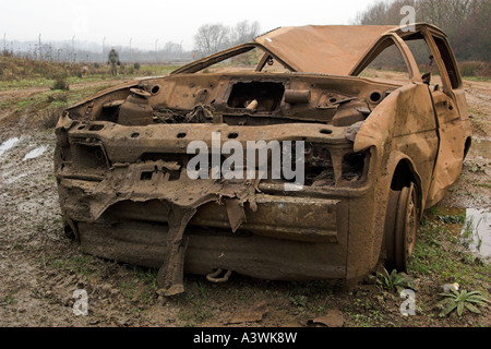 'Burnt out' rusting car abandoned on waste ground, England, UK, 'close up' Stock Photo