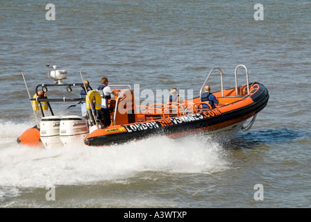 River Thames power boat based on inflatable construction carries out high speed manoeuvres near Canary Wharf Stock Photo