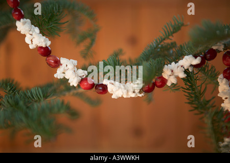 Close-up of Christmas tree with popcorn-cranberry garland - stock