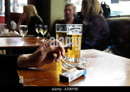 can pubs sell cigarettes uk Smoking cigarette in a smoky pub, UK Stock Photo