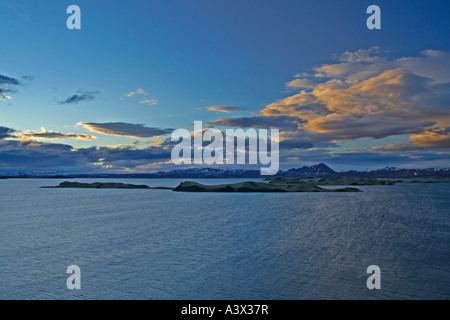 View across Myvatn at dusk Clouds lit by setting sun Iceland Stock Photo