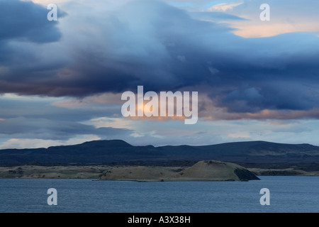 View across Myvatn at dusk Clouds lit by setting sun Iceland Stock Photo