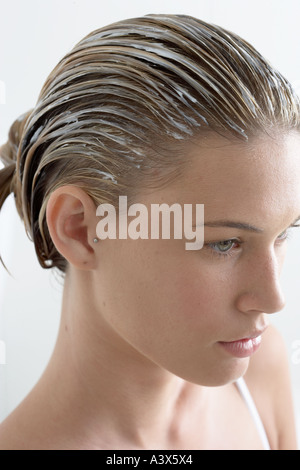 Young woman with cream in hair high angle view Stock Photo