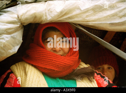 Older gypsy woman with her daughter in traditional gypsy wagon in Romania Stock Photo