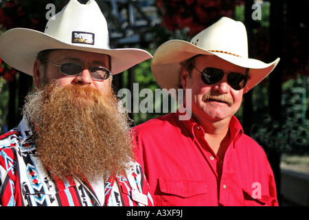 Two cowboy characters sport white hats and a beard for the annual 10 day July Calgary Stampede held in Alberta, Canada. Stock Photo