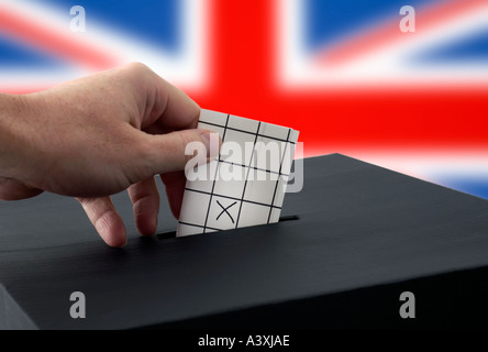 hand putting vote into a ballot box European union brexit Stock Photo