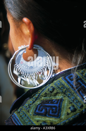 An Hmong woman showing her earring from Bac Ha in Vietnam Stock Photo