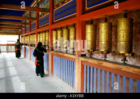 Buddhist devotees spinning prayer wheels at Gong Tang pagoda in Labrang or laburang Si monastery in Xiahe Gansu Province China Stock Photo