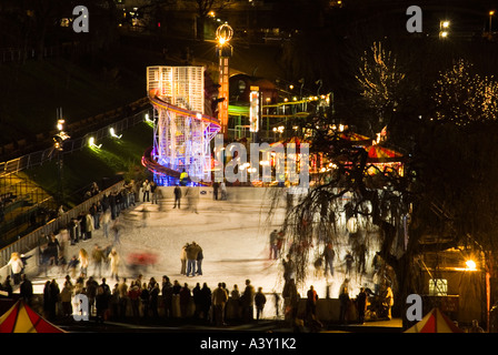 dh  PRINCES ST GARDENS EDINBURGH Winter wonderland ice rink funfair New Year time at night scotland uk festive xmas iceskating christmas street view Stock Photo