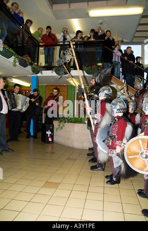 dh Up Helly Aa procession LERWICK SHETLAND Jarl Einar of Gullberuvik and sqaud singing at shopping centre tradition Stock Photo