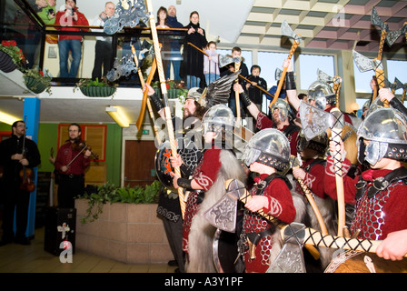 dh Up Helly Aa procession LERWICK SHETLAND Jarl Einar of Gullberuvik and sqaud cheering at  shopping centre people Stock Photo