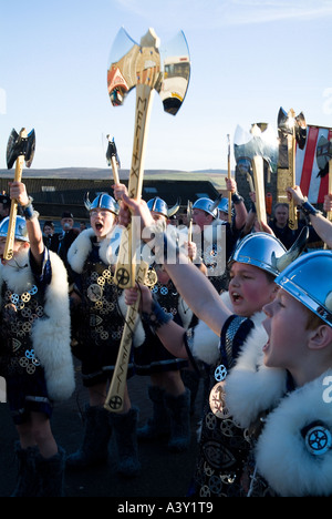 dh Up Helly Aa procession LERWICK SHETLAND Cheering Junior Guizer Jarl Viking squad kids young boys children axe Stock Photo