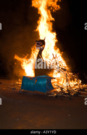 dh Up Helly Aa fire procession LERWICK SHETLAND Viking longship galley Moogi alight at burning site festival shetlands boat Stock Photo