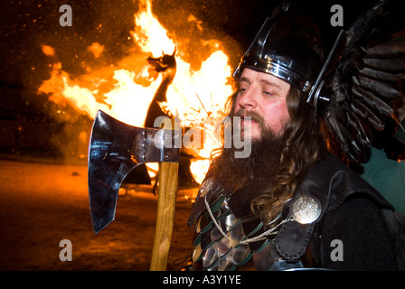 dh Up Helly Aa fire procession LERWICK SHETLAND Guizer Jarl Einar of Gullberuvik Viking longship galley Moogi ship alight man close festival Stock Photo