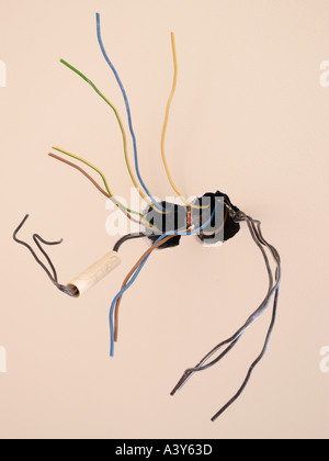 brand new beige wall with many electricity wires coming out of it Stock Photo