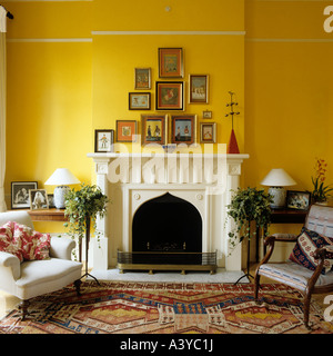 Artwork displayed above fireplace with two armchairs on patterned rug Artwork displayed above fireplace with two armchairs on patterned rug