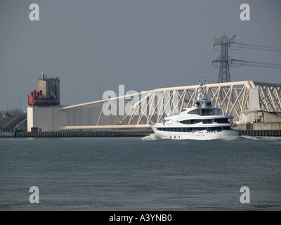 The superyacht Dilbar by Oceanco heading for the North Sea at the Maeslantkering moveable storm barrier near Rotterdam the Nethe Stock Photo