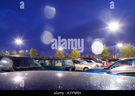 Supermarket parking lot, car park in the rain at night. Early autumn. Virginia USA. Lens flare caused by raindrops on the lens. Stock Photo