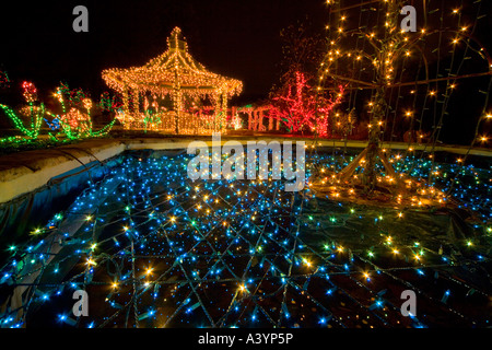 Brookside Gardens Christmas lights display in Wheaton MD near Washington DC USA Tea House folly with pond, fountain and animals. Stock Photo