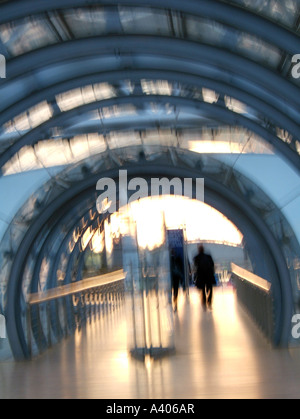 man walking through arches Stock Photo