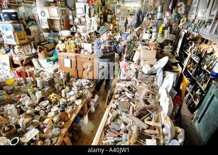 Old man with the thousands of possessions he has hoarded over many decades of never throwing anything away. Stock Photo