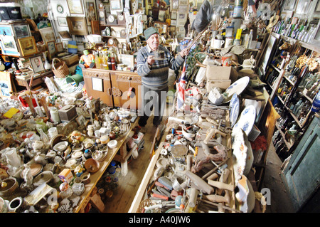 Old man with the thousands of possessions he has hoarded over many decades of never throwing anything away. Stock Photo