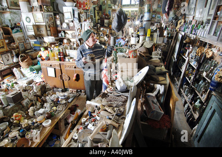 Old man with the thousands of possessions he has hoarded over many decades of never throwing anything away. Stock Photo