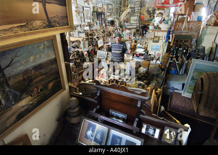 Old man with the thousands of possessions he has hoarded over many decades of never throwing anything away. Stock Photo