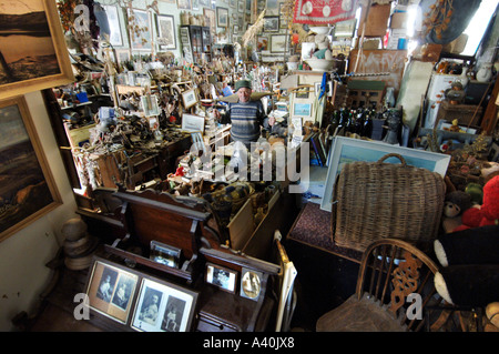 Old man with the thousands of possessions he has hoarded over many decades of never throwing anything away. Stock Photo