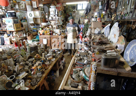 Old man with the thousands of possessions he has hoarded over many decades of never throwing anything away. Stock Photo