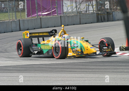 Yellow Turn Racing yellow-green race car speeding around corner during race Stock Photo ...