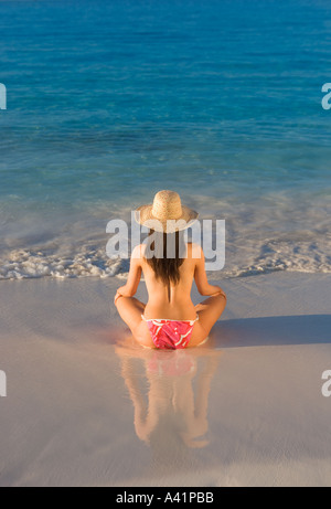 Woman sitting on beach Stock Photo