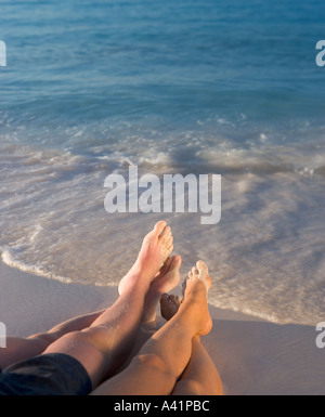Couple relaxing on beach Stock Photo