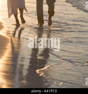 Couple strolling on a beach Stock Photo